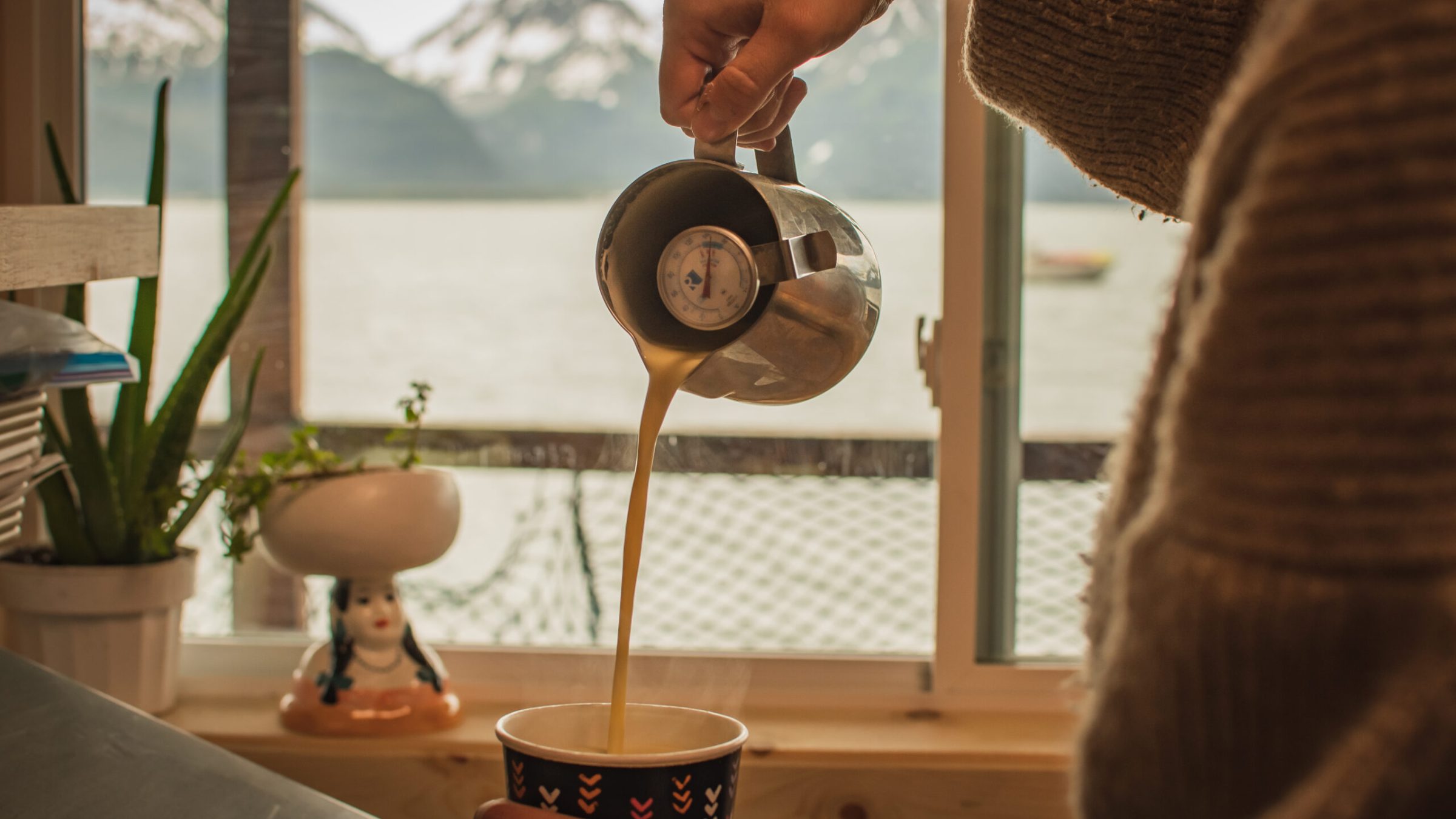 Seaside Beach Seward Alaska Kayaking Fishing Lodging Camping Guided Trips a latte in our cafe space, with mountains in the background