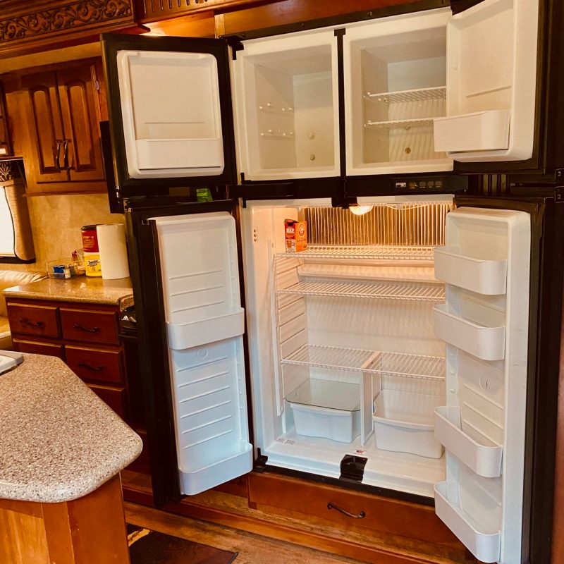 a stove top oven sitting inside of a refrigerator