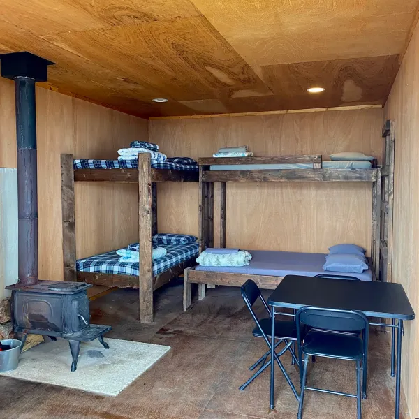 a bedroom with a bed and a chair in a room