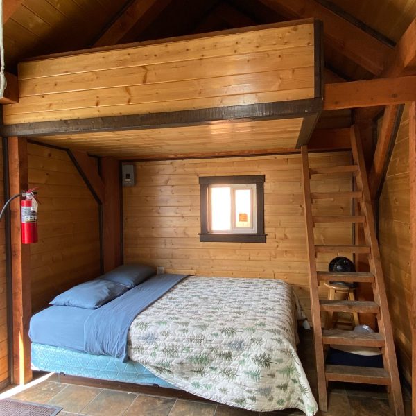 a bedroom with a bed and a chair in a room