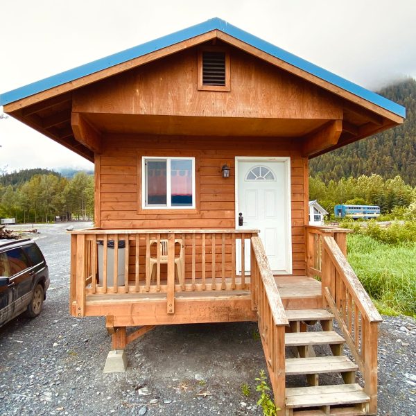 a wooden bench sitting in front of a house