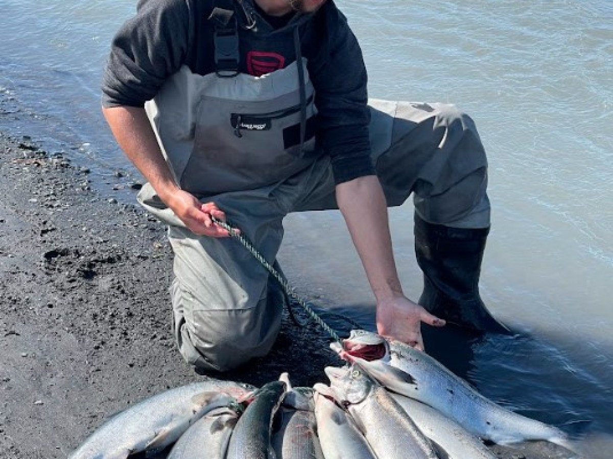 a man holding the fish caught after a day of shore fishing with millers landing
