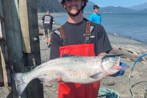 a man holding a fishMillers Landing Seward Alaska Beach Seaside