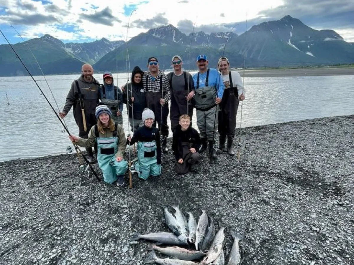 a group of people on a beach near a body of water