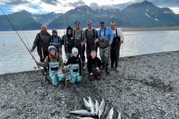 a group of people on a beach near a body of water