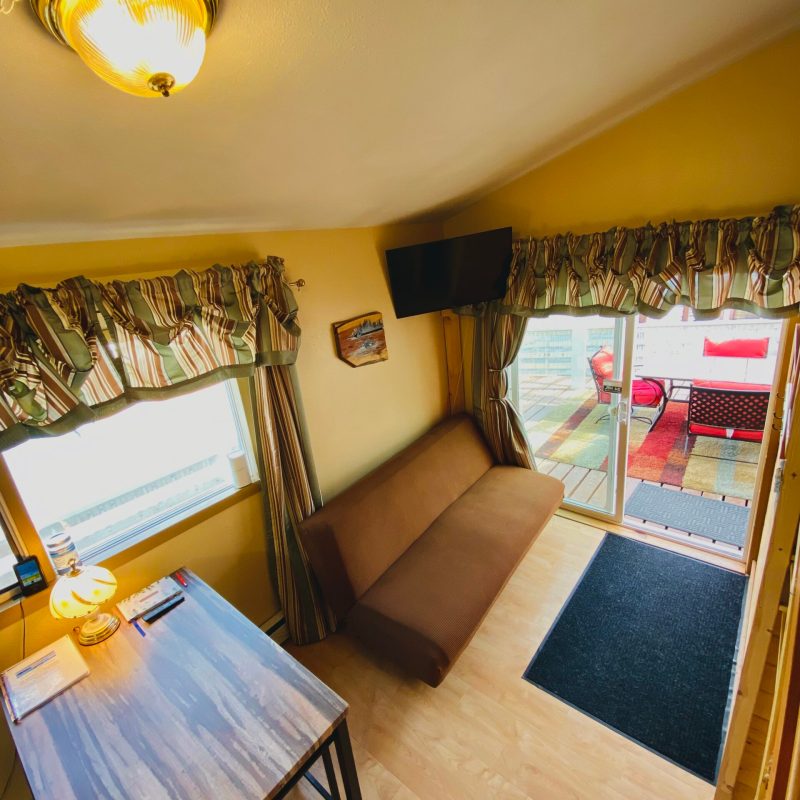 a bedroom with a bed and a chair in a room