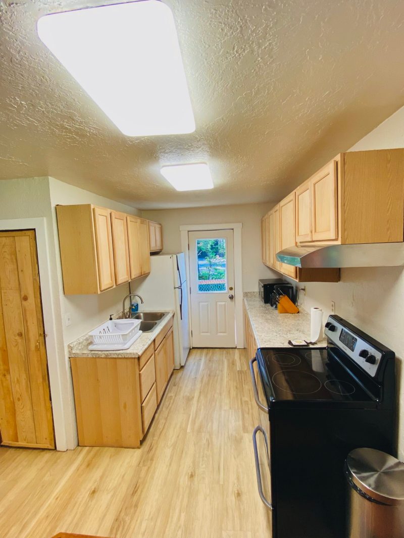 a stove top oven sitting inside of a kitchen