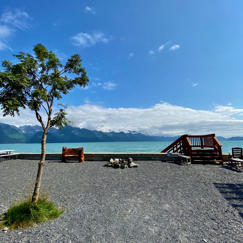 a boat sitting on top of a sandy beach