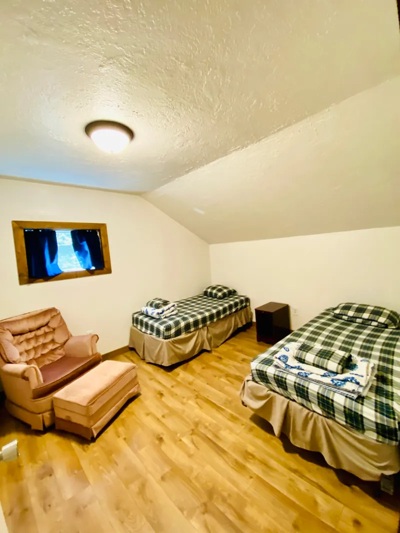 a bedroom with a bed and desk in a room