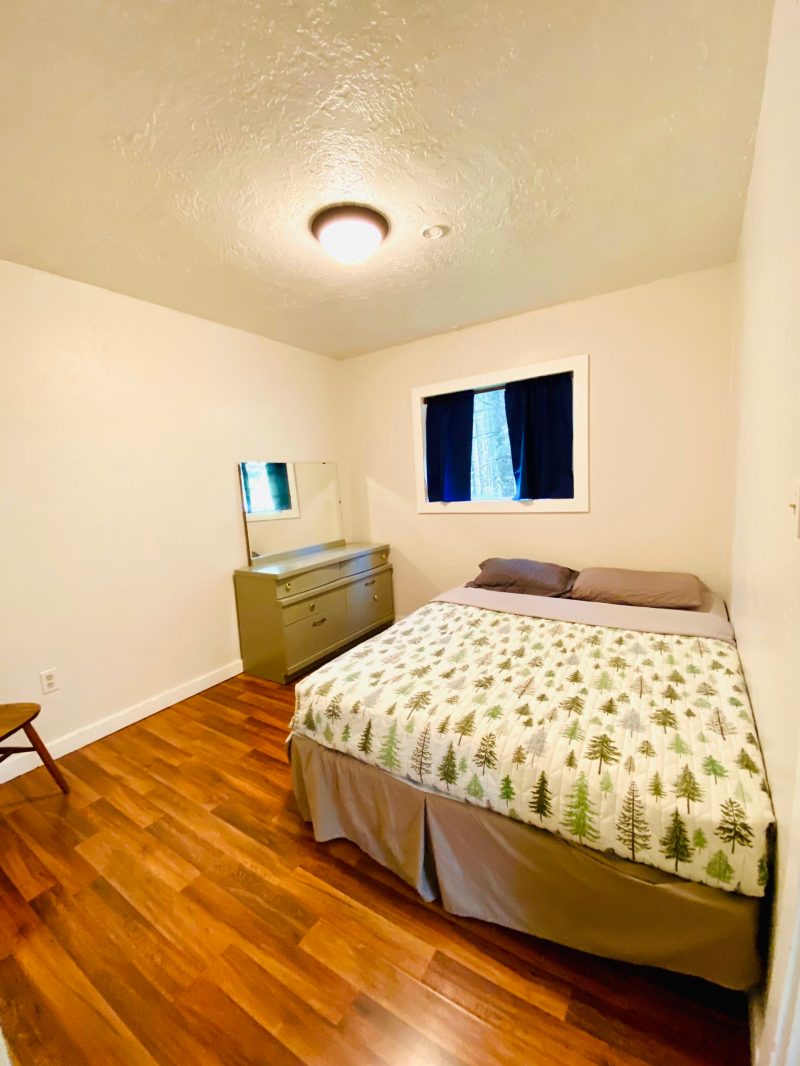 a bedroom with a bed and desk in a room