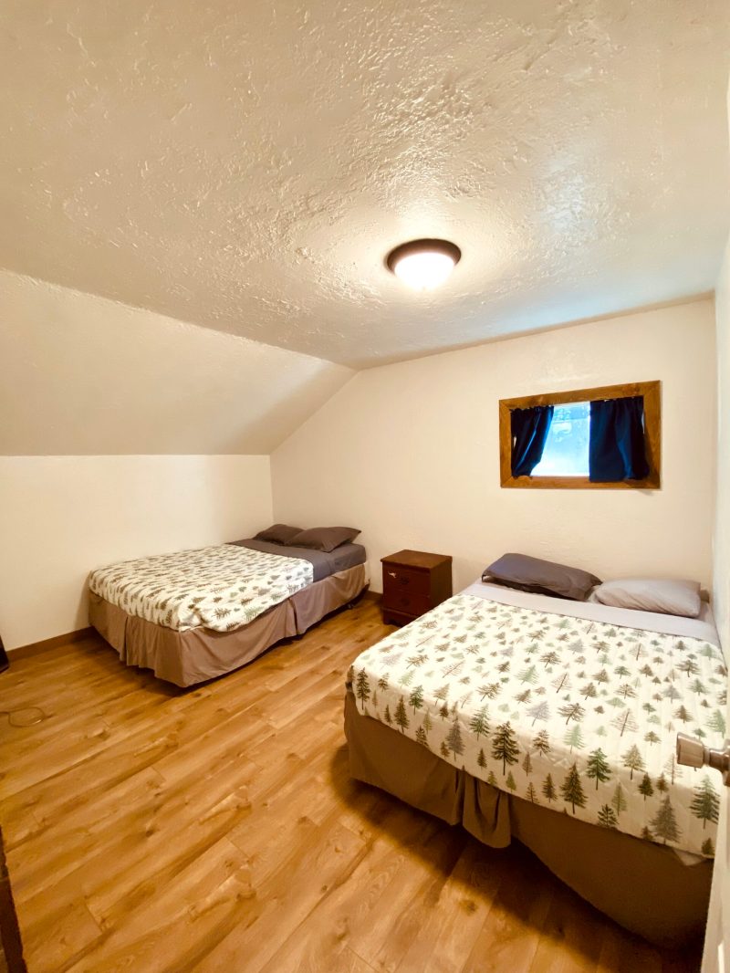 a bedroom with a bed and desk in a room