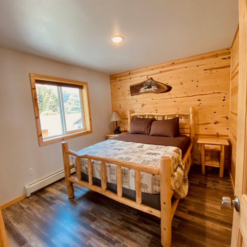 a bedroom with a wooden floor