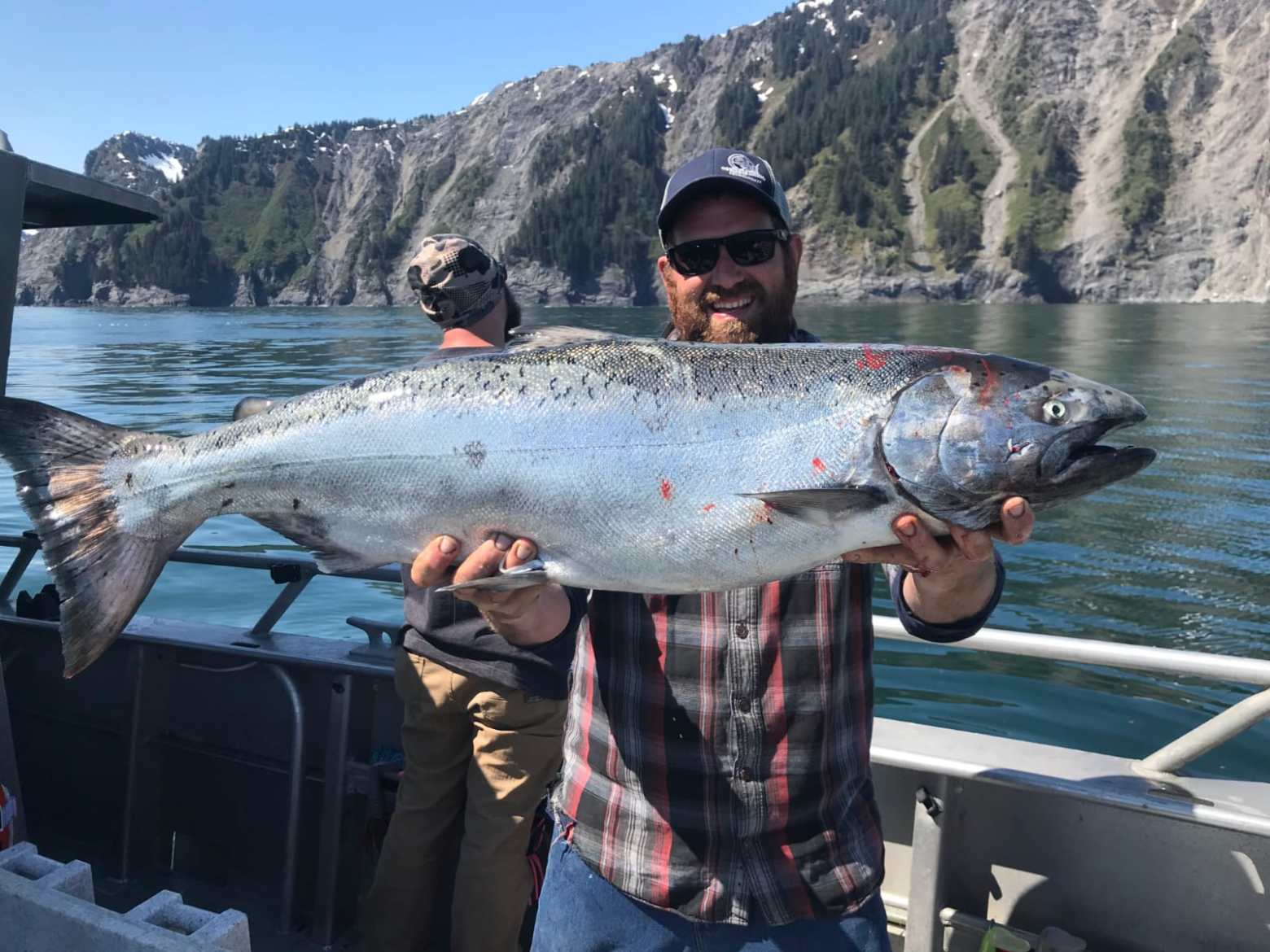 a man holding a fish in the water