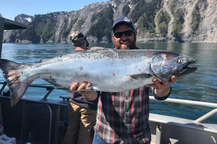 a man holding a fish in the water