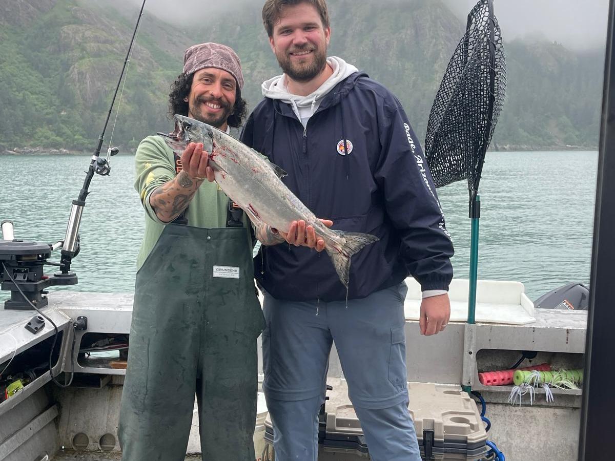 a man holding a fish in the water