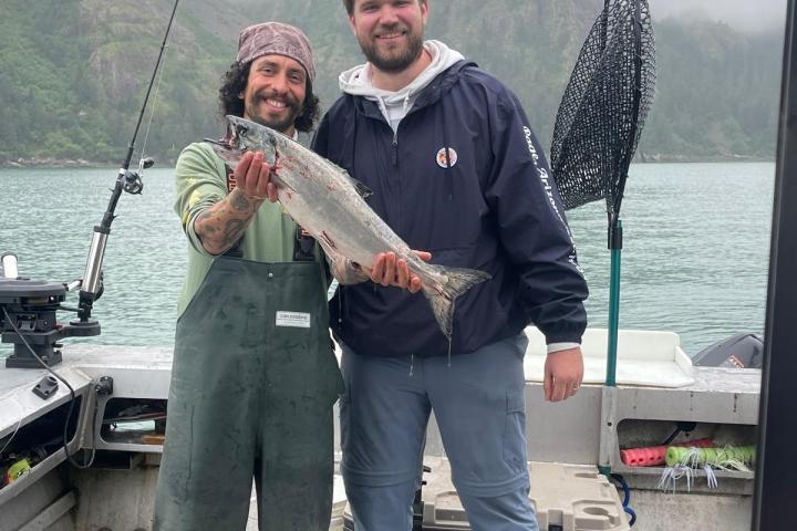 a man holding a fish in the water