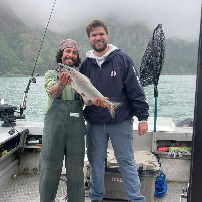 a man holding a fish in the water