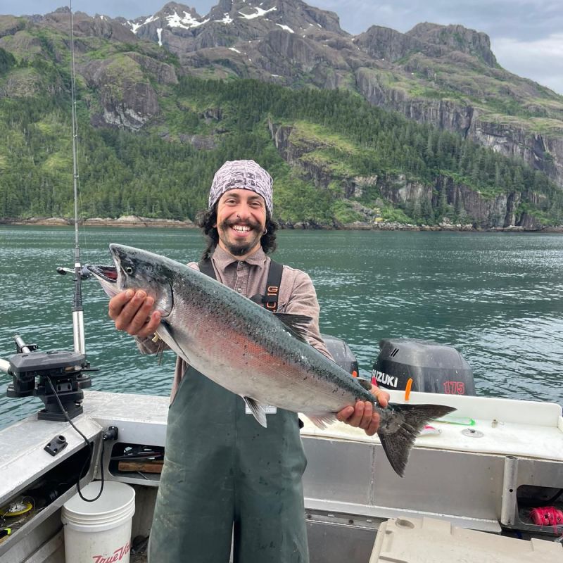 a man holding a fish in the water