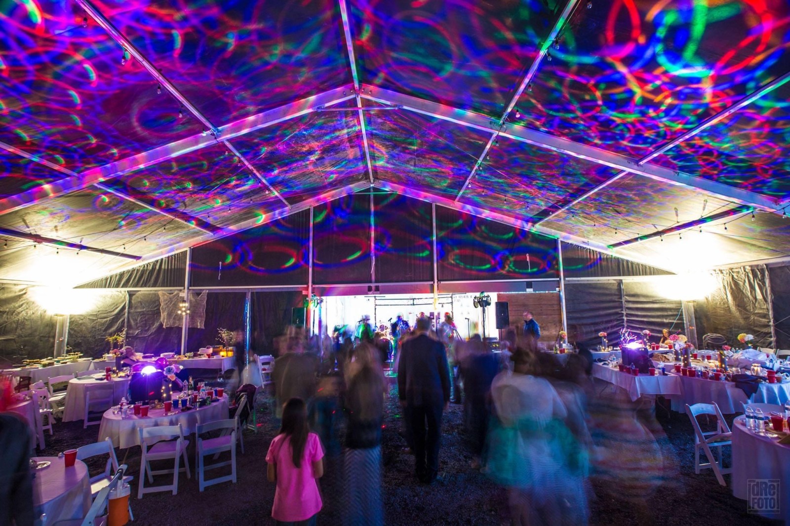 a crowd of people watching a colorful kite