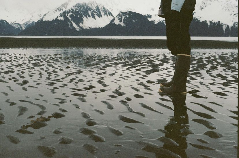 a person standing next to a body of water