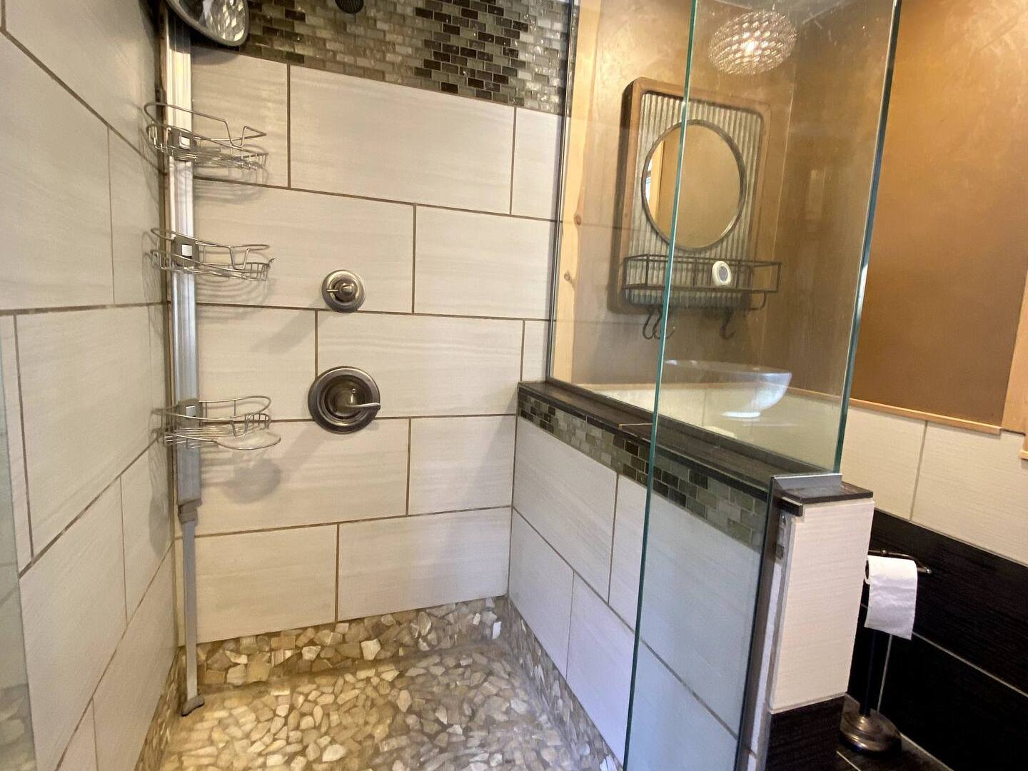 a close up of a walk in shower in a bathroom