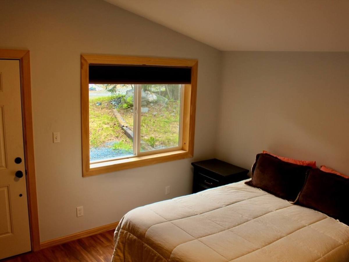 a bedroom with a bed near a window