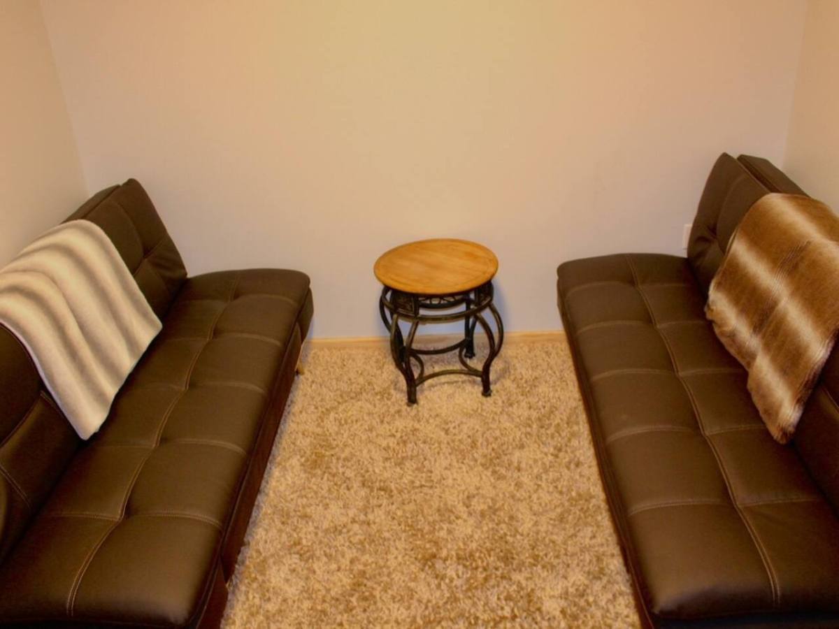 two brown leather couch in a living room