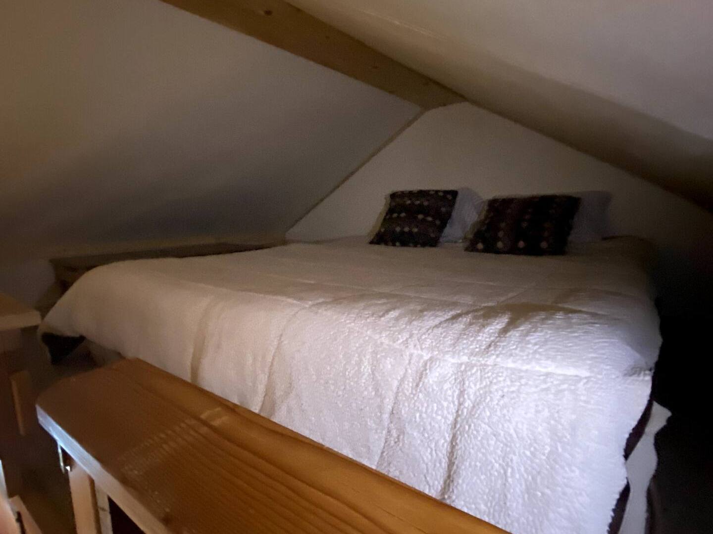 a loft bedroom with a bed