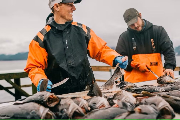 two fisherman cleaning rockfish Millers Landing Seward Alaska Beach Seaside