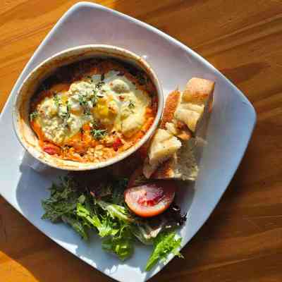 a plate of food sitting on top of a wooden table