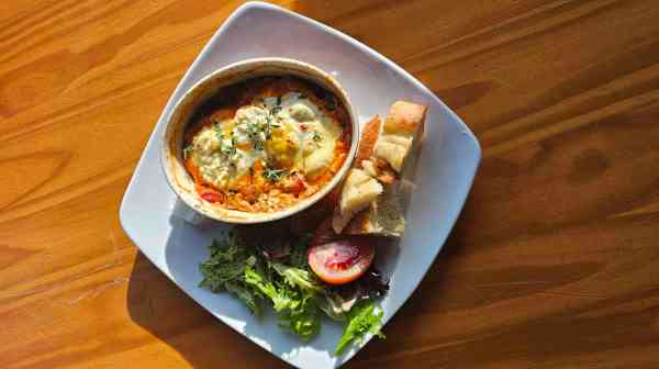 a plate of food sitting on top of a wooden table