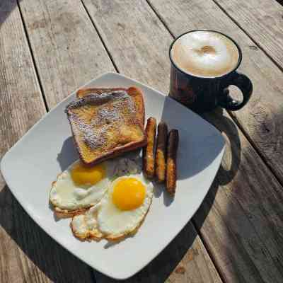 a plate of food and a cup of coffee