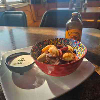 a plate of food with a glass of beer on a table