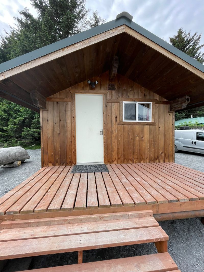 a wooden bench sitting in front of a house