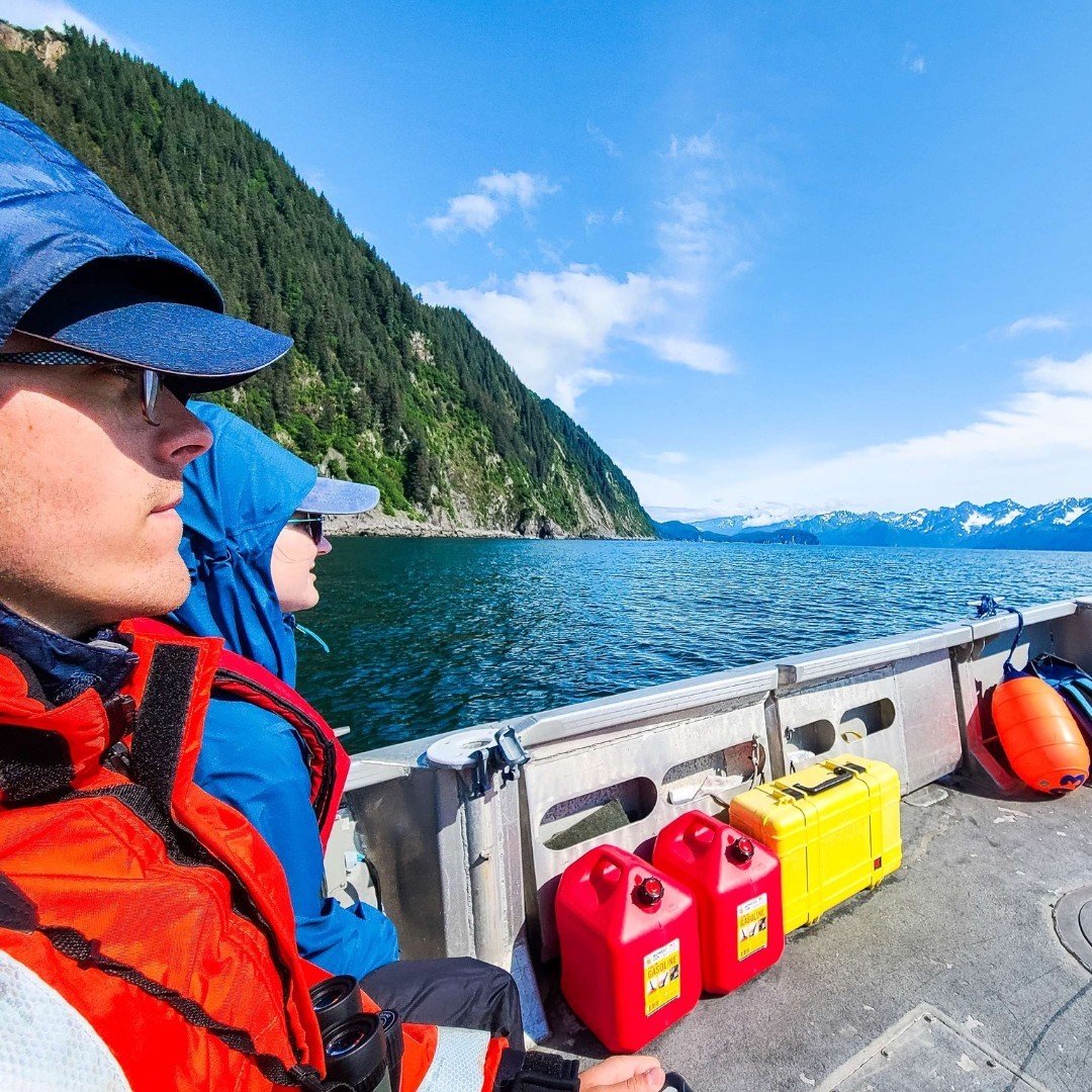 a man sitting on top of a mountain