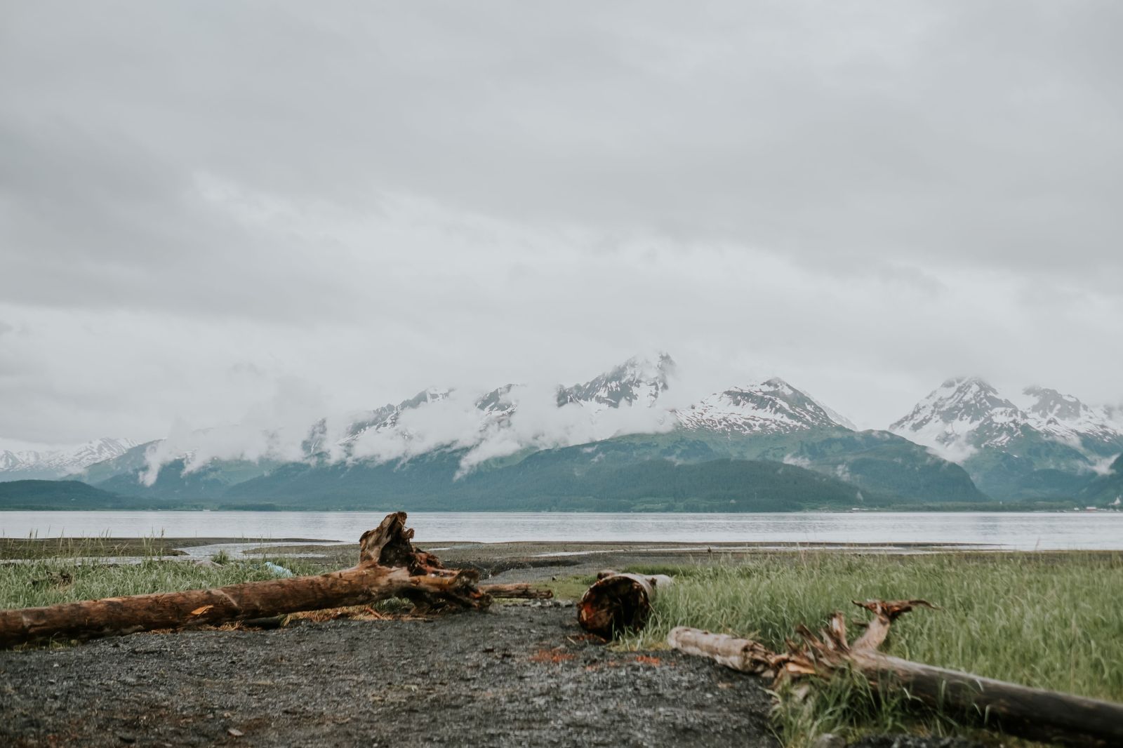 a group of people on a beach near a body of water