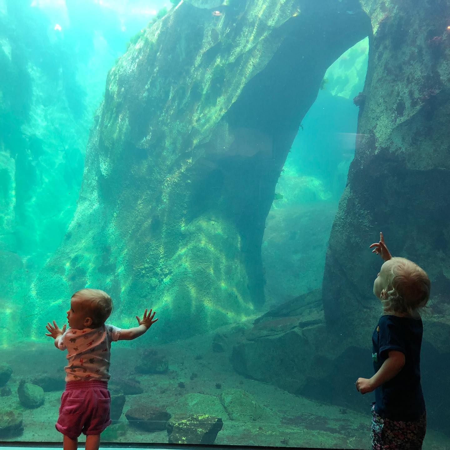 a man and a woman standing in front of water