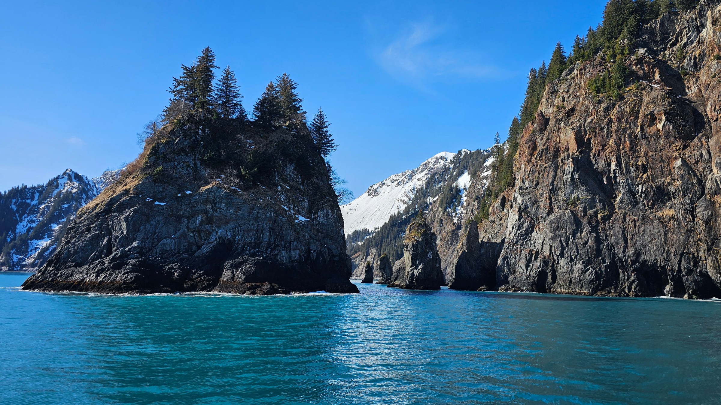a large body of water with a mountain in the background