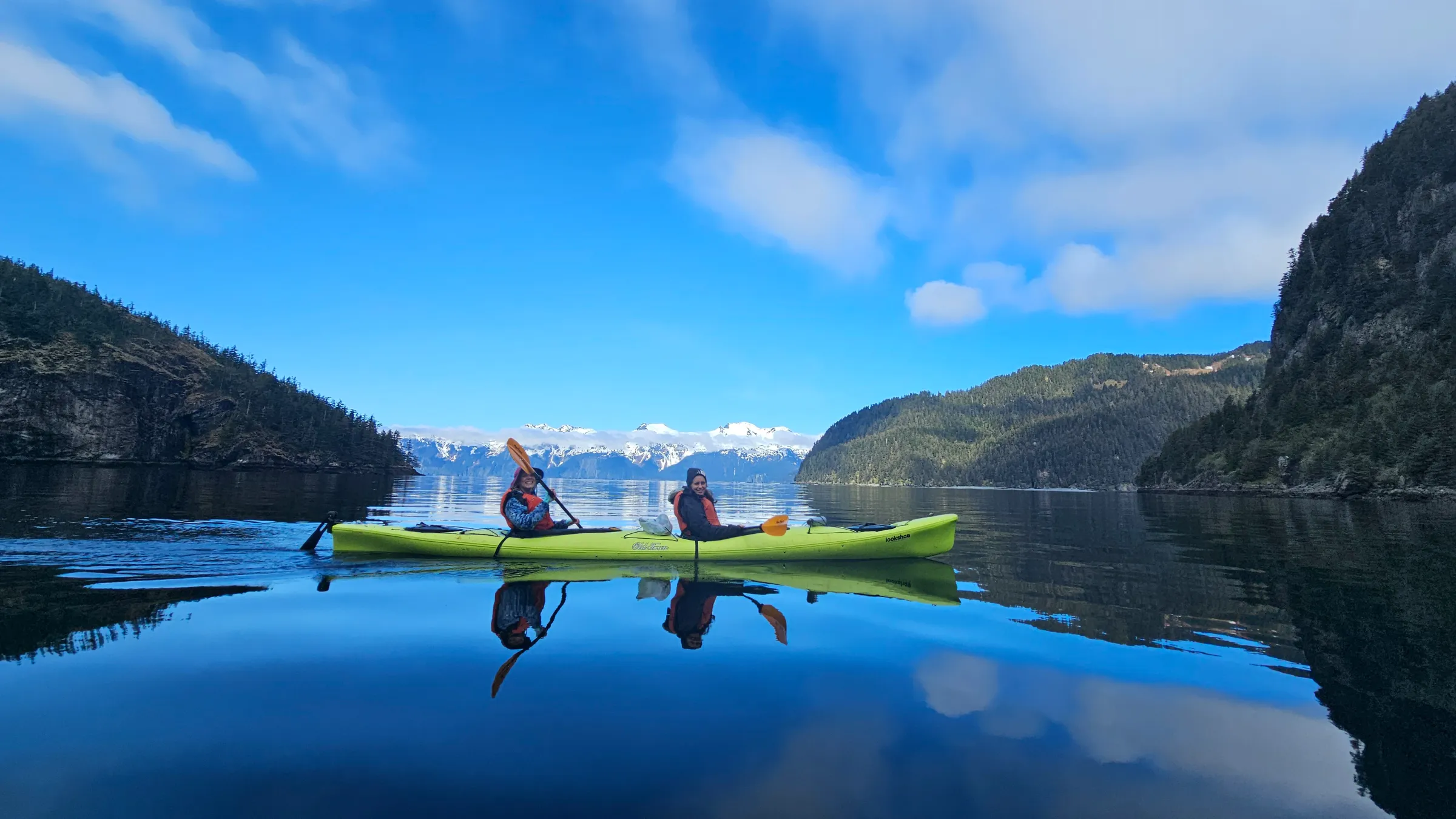 a man riding on the back of a boat in a body of water