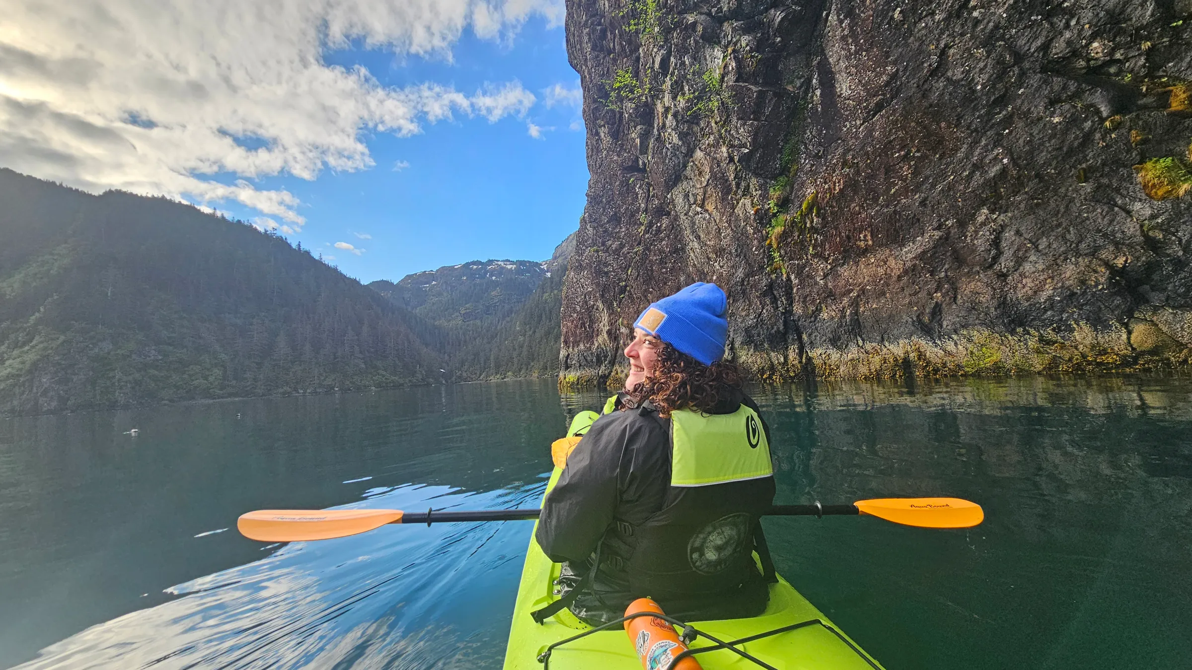 a person standing next to a body of water