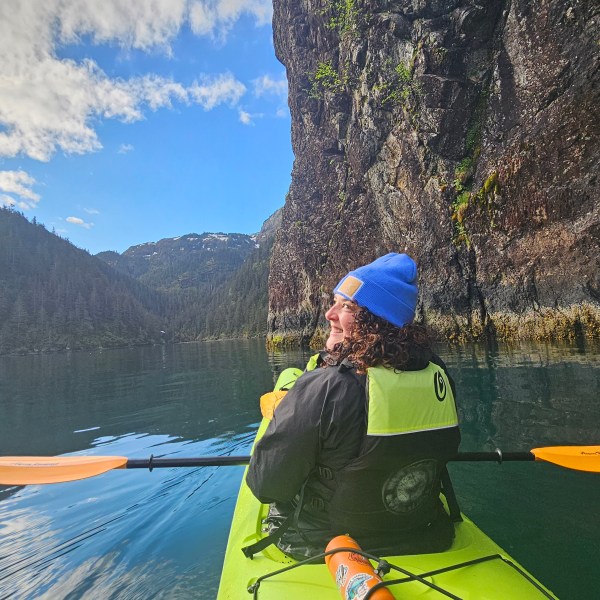 a person standing next to a body of water