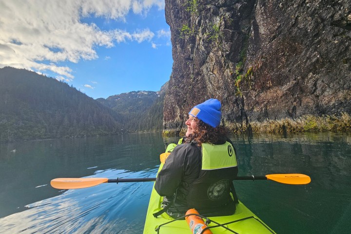 a person standing next to a body of water