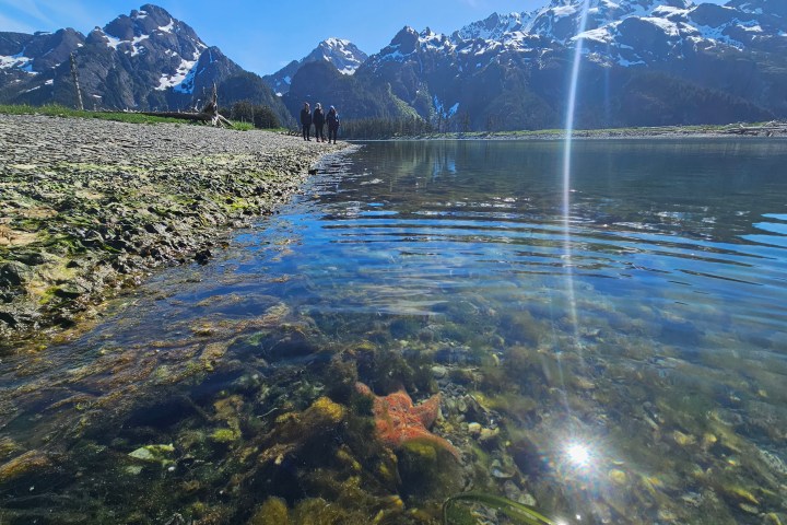 a body of water with a mountain in the background