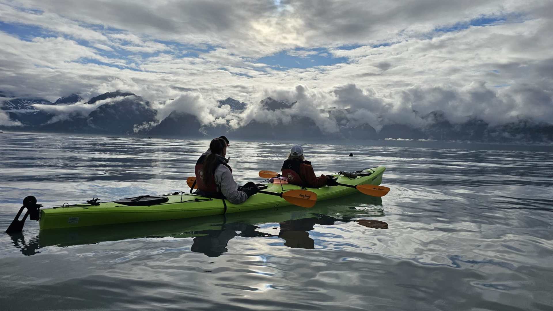 a group of people on a boat in the water
