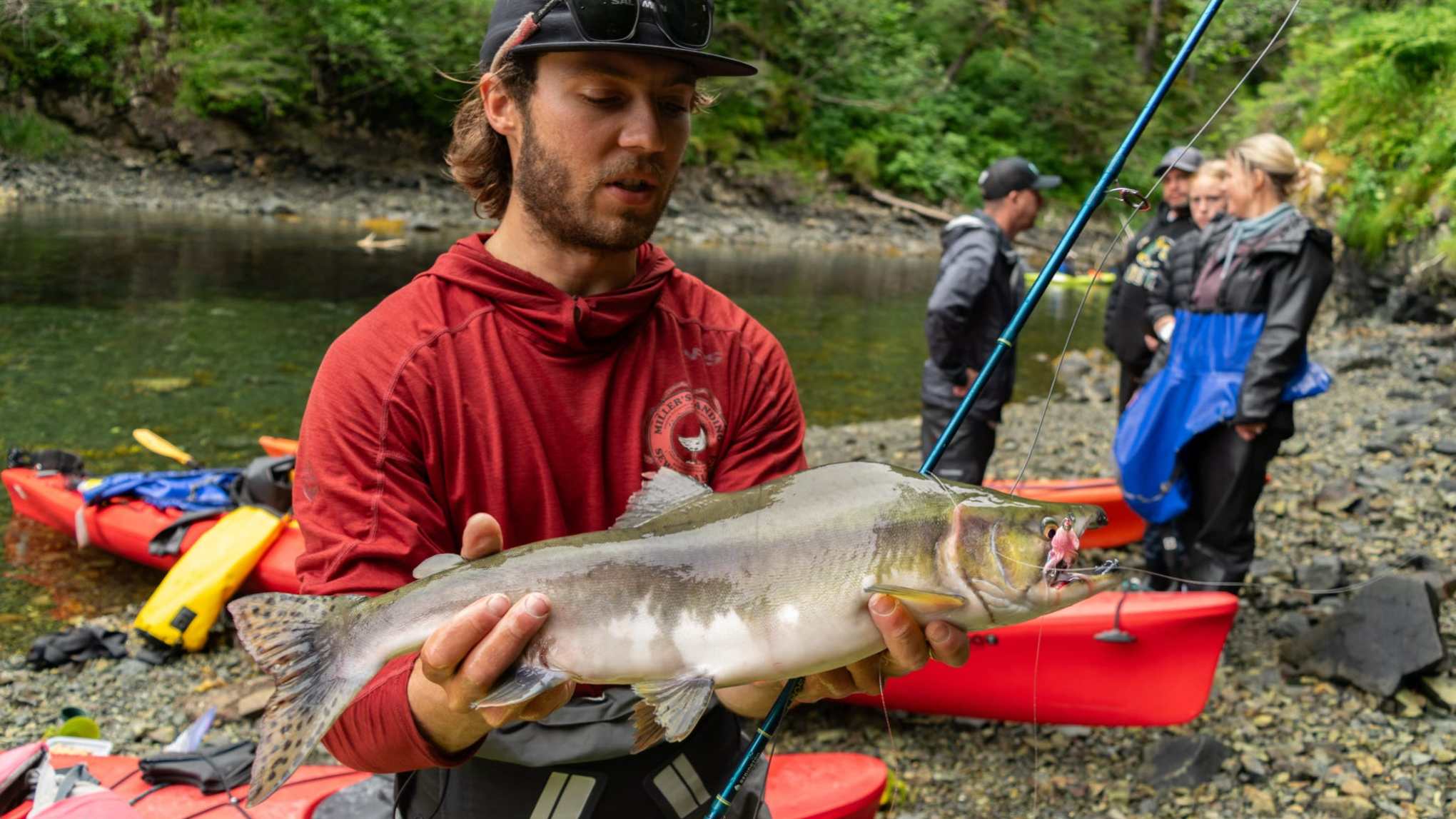a man holding a fish in the water
