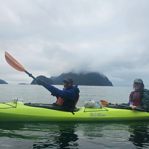 a person riding on the back of a boat in a body of water