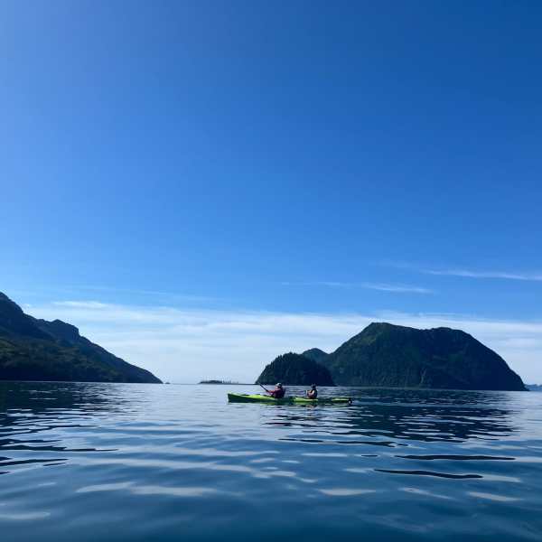 a large body of water with a mountain in the background