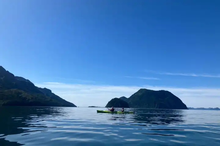 a large body of water with a mountain in the background