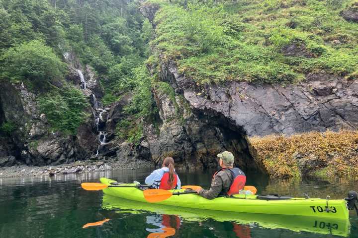 a group of people kayaking outside of Seward Alaska