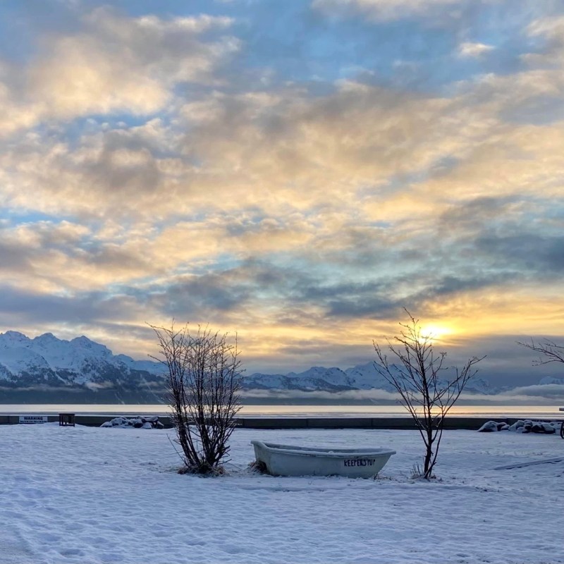 a group of clouds in the sky over a body of water
